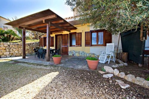 a patio of a house with a table and chairs at Blunda Holiday Home in Castellammare del Golfo