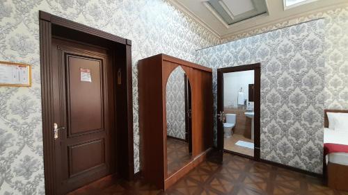 a room with a door and a room with a bathroom at Villa Oasis in Bukhara