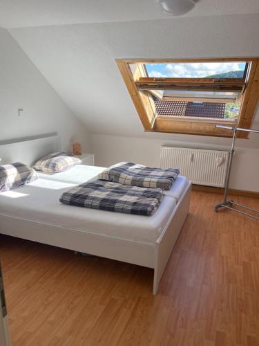 a bedroom with a large bed with a skylight at Eigene Wohnung im Dreifamilienhaus EM2024 plus Ticket auf Anfrage Stadion Stuttgart in Oberstenfeld