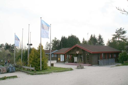 a building with two flags in front of it at Ferienpark Lauterdörfle 9 in Hayingen