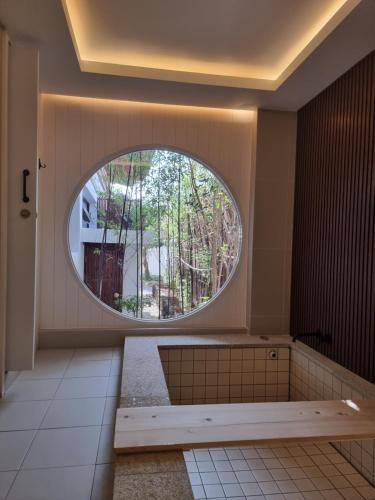 a bathroom with a large circular window in a room at Yeonriji in Gyeongju