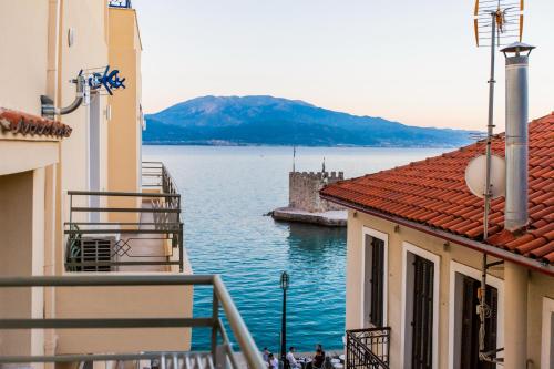 a view of a body of water between two buildings at Vip Lepanto Castle Suites in Nafpaktos