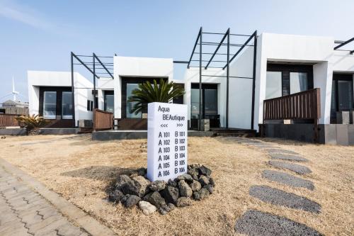 a sign in front of a house at Aqua Beautique Poolvilla in Jeju