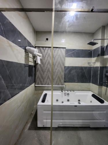 a bathroom with a bath tub and a shower at THE BODHI PALACE RESORT in Bodh Gaya