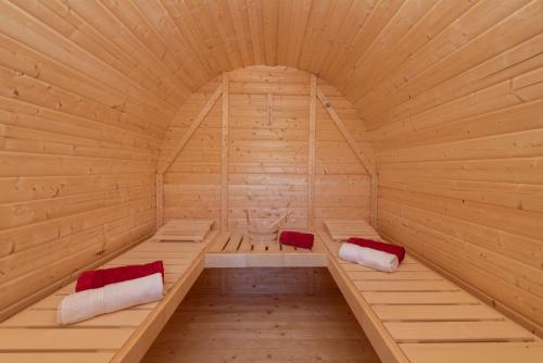 a large wooden sauna with two beds in it at Heustadl Zillertal in Zell am Ziller