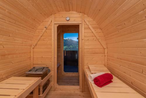 an inside view of a wooden cabin with benches and a window at Heustadl Zillertal in Zell am Ziller