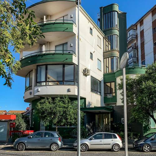 a building with cars parked in front of it at Hotel del Sole-Aversa in Aversa