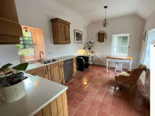 una cocina con encimera y mesa. en Roberts Yard Country Cottage en Kilkenny