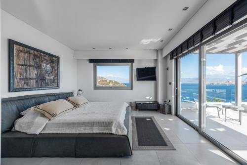 a bedroom with a bed and a view of the ocean at Villa Soligia Blue in Pefkali