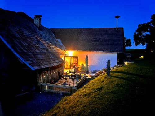 a house with a fire pit in front of it at Haus Tilia Karinthië Appartementen in Nötsch