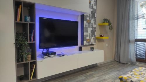 a living room with a television on a white entertainment center at Art Studio Vinitsa in Varna City