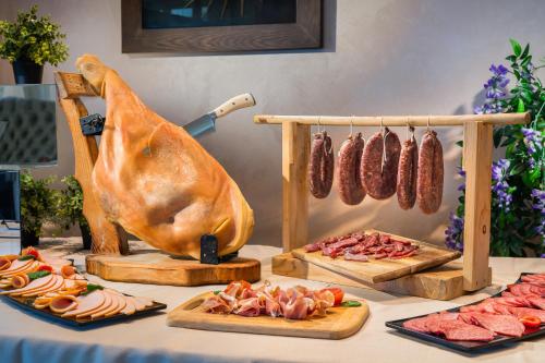 a table with sausages and other meats on display at Park & Spa Hotel Markovo in Plovdiv