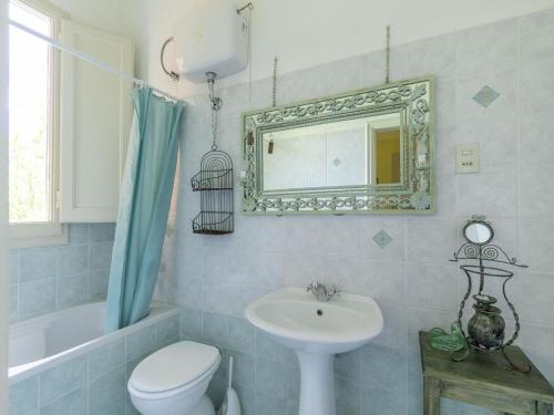 a bathroom with a sink and a toilet and a mirror at Holiday Home Tuscany with Pool Access in Marti