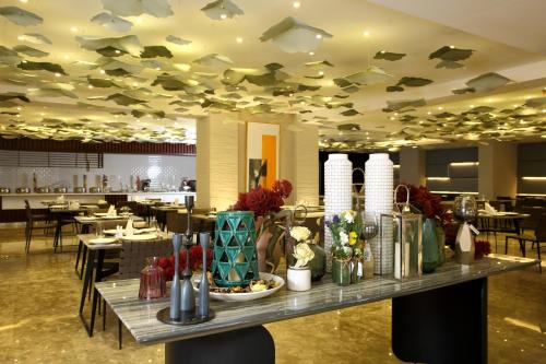 a restaurant with a table with food on it at Grand Plaza Hotel - Jazan in Jazan