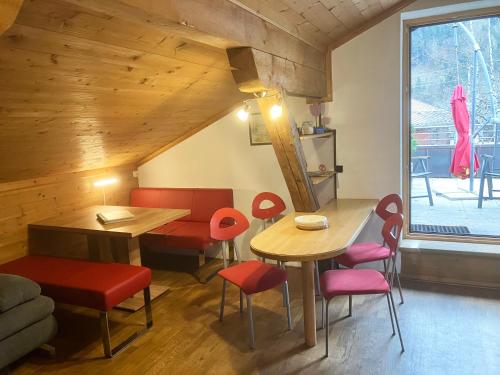 jadalnia ze stołem i czerwonymi krzesłami w obiekcie Gästehaus Katharina w mieście Hochfilzen