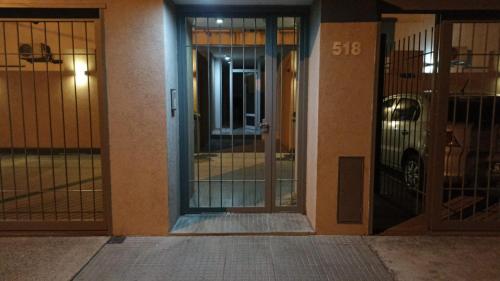 an entrance to a building with glass doors with a car at LA ESTACION in Gualeguaychú