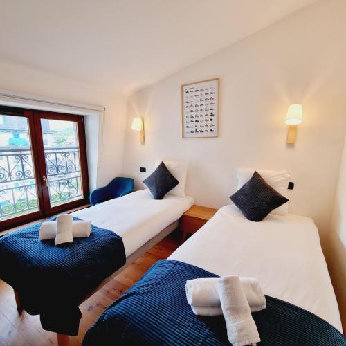 En eller flere senge i et værelse på ALPES IV - Hyper Centre - Parking - 40m²