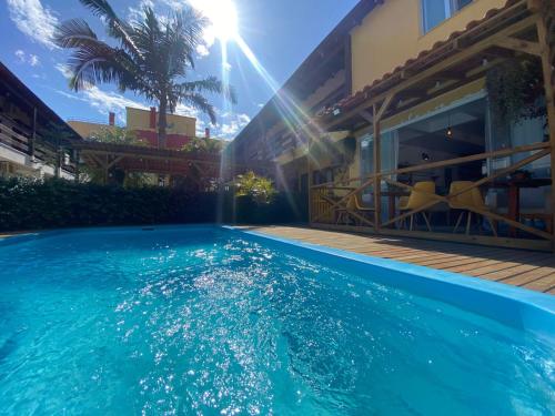 a swimming pool in front of a house at Hotel Fênix in Florianópolis