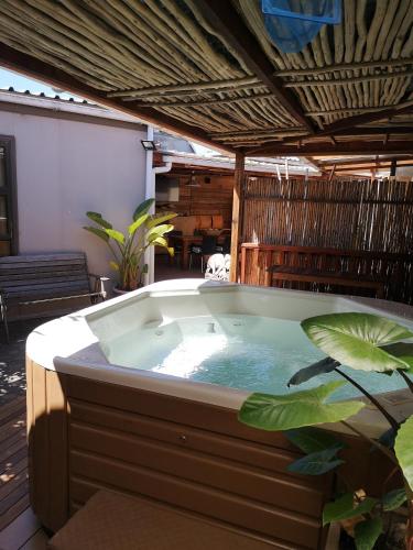 a jacuzzi tub in the middle of a patio at Bona Lodge in Cape Town