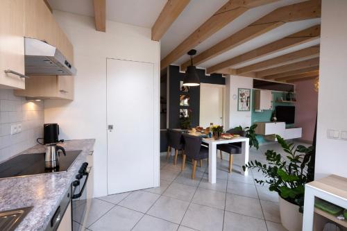 a kitchen and dining room with a table and chairs at FLOW Village Apartment in Sarntal