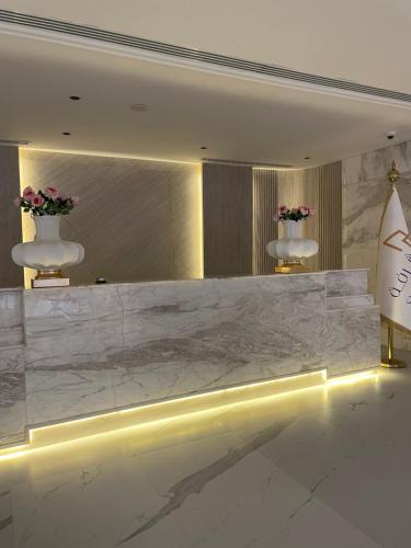 a lobby with a large marble counter with lights at شرفة in Riyadh
