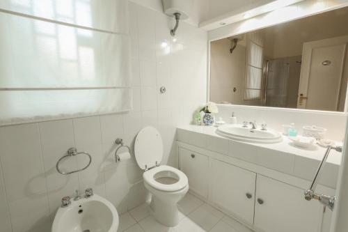 a bathroom with a toilet and a sink and a mirror at Lake&More in Trevignano Romano