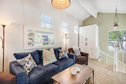 a living room with a blue couch and a table at Green River Lodge - Lake LBJ in Burnet