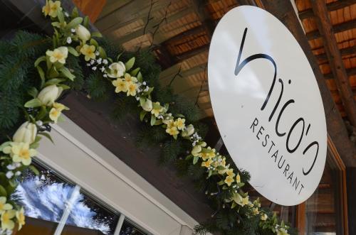 a sign for a flower shop with flowers on it at Toni's Alpine Loft & SPA in Kandersteg