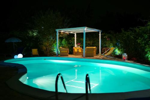 a swimming pool at night with a gazebo at Lake&More in Trevignano Romano