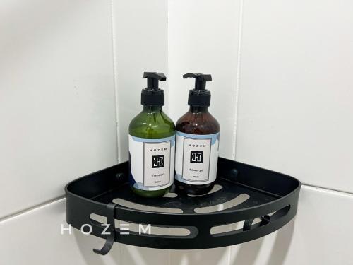 two bottles of wine sitting in a black holder at 3BR3B Hozem KL1108 Apartment Kepong in Kuala Lumpur