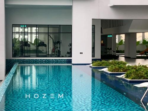 a swimming pool in the middle of a building at 3BR3B Hozem KL1108 Apartment Kepong in Kuala Lumpur