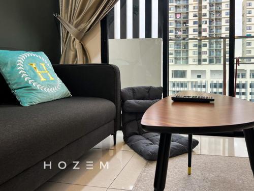 a living room with a couch and a table at 3BR3B Hozem KL1108 Apartment Kepong in Kuala Lumpur