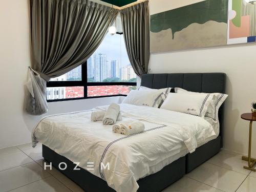 a bedroom with a bed with two towels on it at 3BR3B Hozem KL1108 Apartment Kepong in Kuala Lumpur