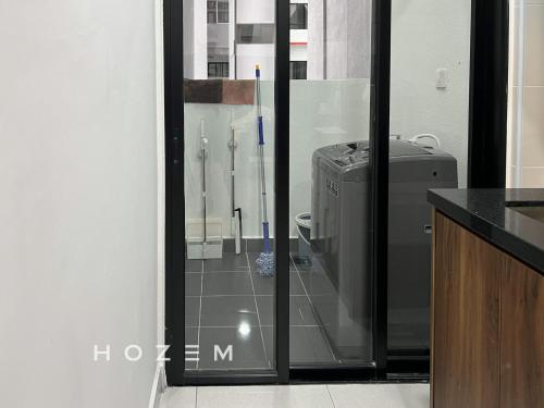 a bathroom with a glass door with a refrigerator at 3BR3B Hozem KL1108 Apartment Kepong in Kuala Lumpur