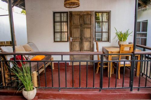 a balcony with a table and chairs and a door at Blue elephant villas in Arusha