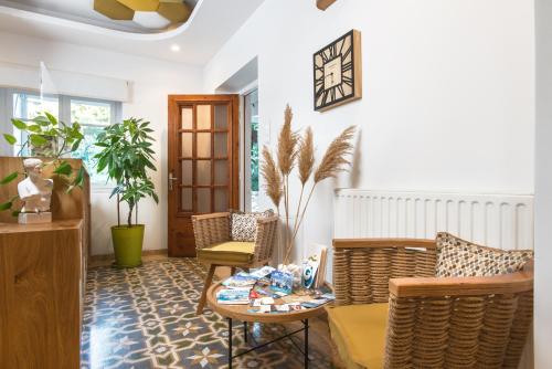 a living room with wicker chairs and a table at Semiramis Guesthouse in Adamas