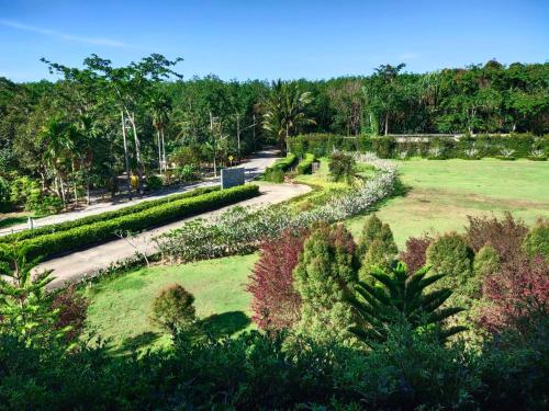 an aerial view of a park with trees and a road at Khaolak Blue Sky Villa in Khao Lak