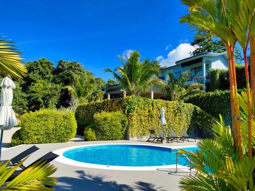 a swimming pool in front of a house at Khaolak Blue Sky Villa in Khao Lak