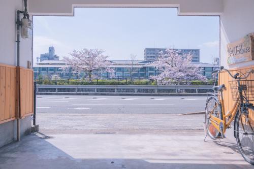 a bike parked on the side of a building at Kamo River J~House in Kyoto