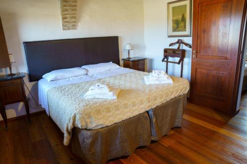 a bedroom with a bed with two towels on it at La Lepre Bianca in Cento