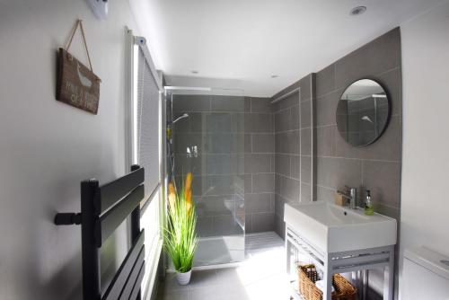 a bathroom with a sink and a mirror at Arthouse Canterbury-Free Secure Parking in Canterbury
