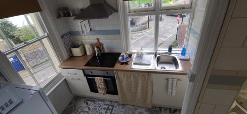 a small kitchen with a sink and a window at Westend in Ryde