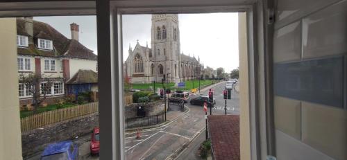 a window with a view of a church and a street at Westend in Ryde