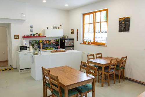 a kitchen and dining room with a table and chairs at BikeSki family hotel, b&b, apartaments, rooms in Mežica