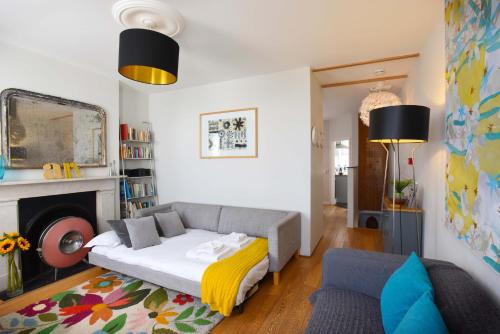 a living room with a bed and a fireplace at Arthouse Canterbury-Free Secure Parking in Canterbury