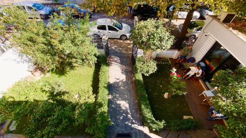 an overhead view of a yard with trees and a car at Hotel Antigone in Tirana