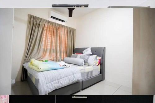 a bedroom with a bed with pillows and a window at New Condo SYMPHONY II in Kajang , Semenyih in Semenyih