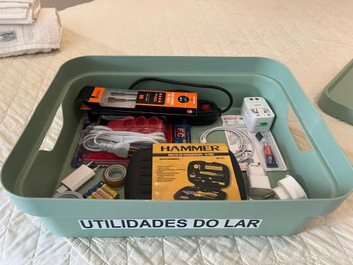 a plastic container filled with tools and other items at Loft 319 - INCOMPARÁVEL in Itacuruçá
