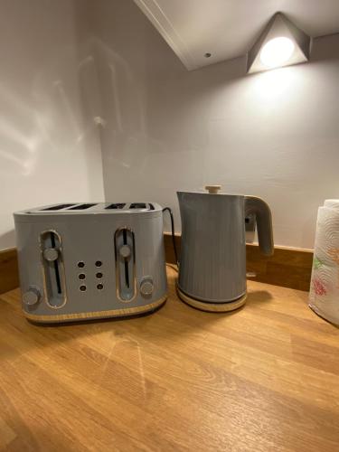 a toaster and coffee pot sitting on a table at Cosy Loft Apartment in Ballycastle