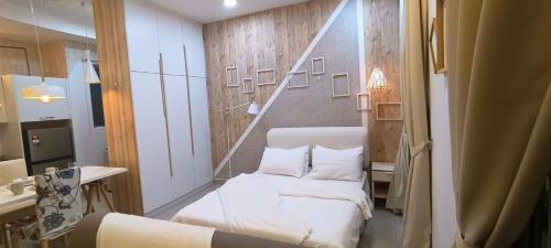 a small room with two beds and a mirror at Peace home apex in Cyberjaya